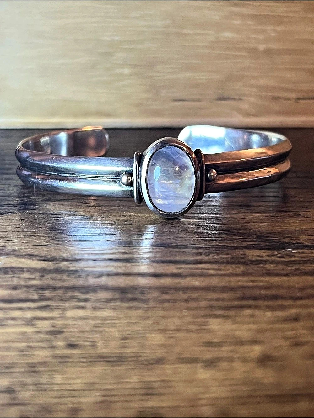 Adjustable sterling silver cuff bracelet with rainbow moonstone center gem